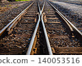 old railway crossing point that uses wooden supports for the steel bars. 140053516