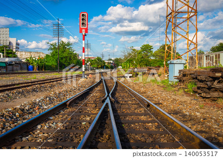 railway traffic light at an old transfer point with power lines and wooden tracks as a backdrop. railway traffic light at an old transfer point with power lines and wooden tracks as a backdrop. 140053517