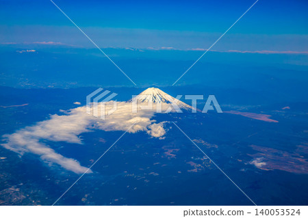 Mount Fuji seen from an airplane on a beautiful blue day with snow on the peak Mount Fuji seen from an airplane on a beautiful blue day with snow on the peak 140053524
