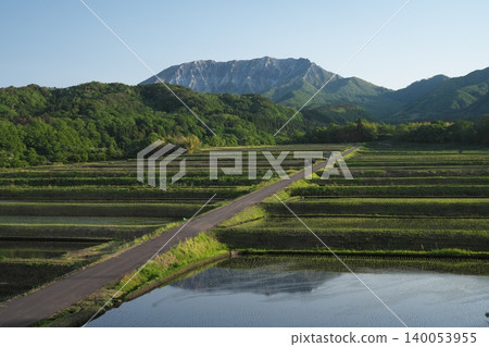 Springtime views of the southern face of Mt. Daisen in Tottori Prefecture and the terraced rice fields of Mitsume. 140053955