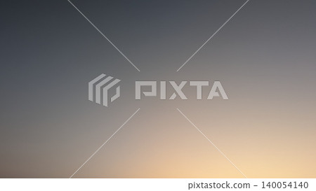 Minimalist background texture features a smooth dark gradient backdrop. A soft orange sunrise glow transitions into deep twilight gray tones, offering a clean abstract sky layout. Minimalist background texture features a smooth dark gradient backdrop. A soft orange sunrise glow transitions into deep twilight gray tones, offering a clean abstract sky layout. 140054140