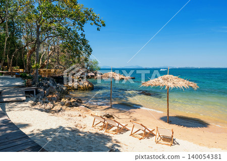 sunbeds and parasols of cafe by seashore at Ko Man Klang, Rayong sunbeds and parasols of cafe by seashore at Ko Man Klang, Rayong 140054381