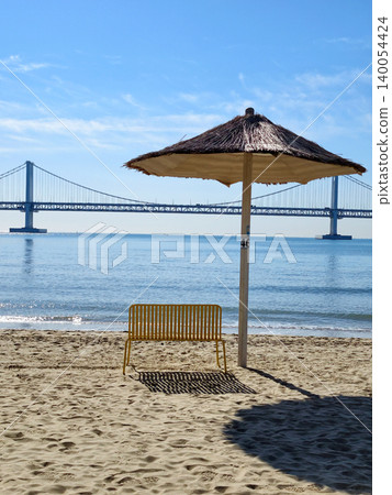 Yellow chair on Gwangalli Beach with view of Gwangan Bridge, Busan Yellow chair on Gwangalli Beach with view of Gwangan Bridge, Busan 140054424