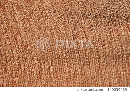 Background image of a light orange fabric pattern illuminated by sunlight. Background image of a light orange fabric pattern illuminated by sunlight. 140054489