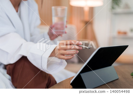 morning routine woman hand holding glass water using digital tablet with stylus pen home relaxed lifestyle healthy hydration wellness technology browsing morning routine woman hand holding glass water using digital tablet with stylus pen home relaxed lifestyle healthy hydration wellness technology browsing 140054498