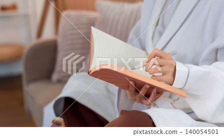 Asian women writing journal notebook sitting cozy sofa morning routine planning daily schedule wellness activity mindful practice self care reflection personal Asian women writing journal notebook sitting cozy sofa morning routine planning daily schedule wellness activity mindful practice self care reflection personal 140054501