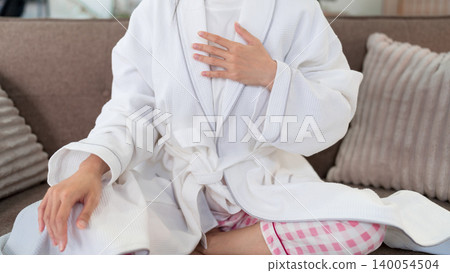 Asian women morning routine wearing white bathrobe sitting on sofa relaxing at home wellness selfcare lifestyle concept comfortable loungewear cozy living room Asian women morning routine wearing white bathrobe sitting on sofa relaxing at home wellness selfcare lifestyle concept comfortable loungewear cozy living room 140054504