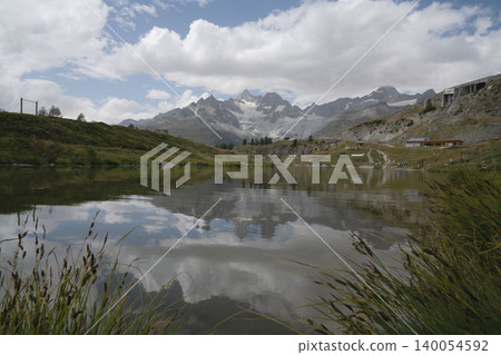 Turquoise Lake and the Matterhorn near Zermatt, Switzerland; summer highlands; stunning Swiss scenery in mid-August. Turquoise Lake and the Matterhorn near Zermatt, Switzerland; summer highlands; stunning Swiss scenery in mid-August. 140054592