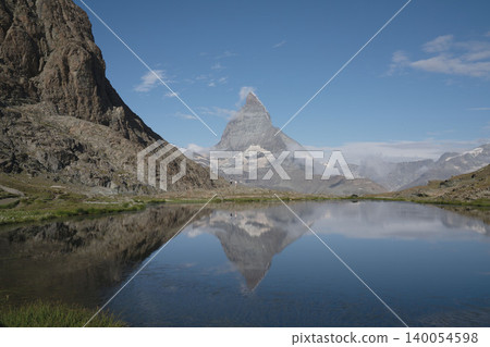 A panoramic view of the Matterhorn and snow-capped mountains from Gornergrat in Switzerland, a breathtaking summer scene in the Swiss Alps in August. A panoramic view of the Matterhorn and snow-capped mountains from Gornergrat in Switzerland, a breathtaking summer scene in the Swiss Alps in August. 140054598