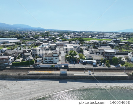 Aerial footage of the Shimabara Railway on a clear day, showing Omisato Station and the Ariake Sea, Nagasaki Prefecture. Aerial footage of the Shimabara Railway on a clear day, showing Omisato Station and the Ariake Sea, Nagasaki Prefecture. 140054698