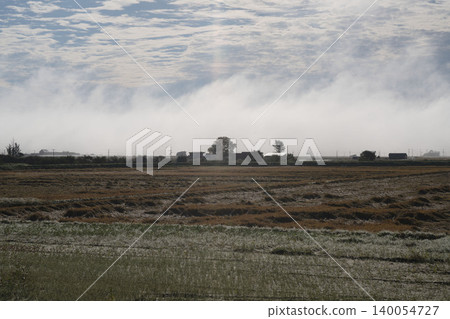 Morning mist and rural landscapes in Hokkaido, a panoramic view of fields and farms in early autumn morning in September, a panoramic view of morning mist in Hokkaido. Morning mist and rural landscapes in Hokkaido, a panoramic view of fields and farms in early autumn morning in September, a panoramic view of morning mist in Hokkaido. 140054727