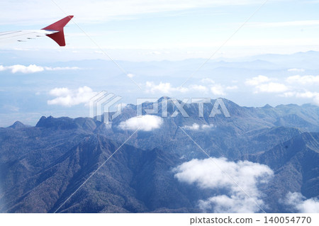 A panoramic view of late autumn mountains and lakes, and vibrant autumn foliage from inside the plane; a stunning aerial view of late autumn in October. 140054770