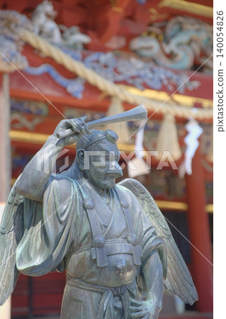 Mount Takao in the sparkling spring sunshine, watched over by a mystical Tengu statue. Mount Takao in the sparkling spring sunshine, watched over by a mystical Tengu statue. 140054826