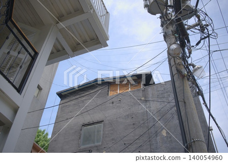 The power lines woven against the blue May sky evoke the nostalgia of downtown Seoul, South Korea. The power lines woven against the blue May sky evoke the nostalgia of downtown Seoul, South Korea. 140054960