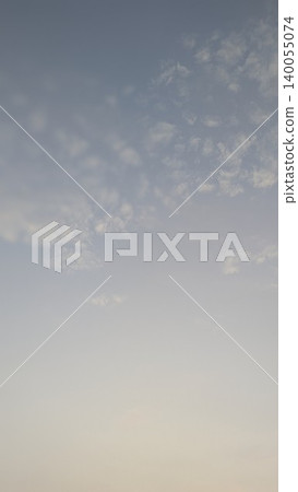 A soft vertical gradient of a sunrise sky, with a light blue at the top fading into a pale orange/yellow at the bottom. Wispy cirrus clouds dot the top half. A soft vertical gradient of a sunrise sky, with a light blue at the top fading into a pale orange/yellow at the bottom. Wispy cirrus clouds dot the top half. 140055074