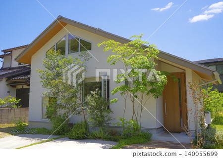 Exterior view of a detached house with a garden surrounded by nature Exterior view of a detached house with a garden surrounded by nature 140055699