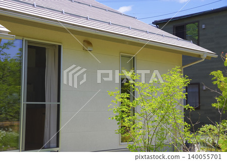 Exterior view of a detached house with a garden surrounded by nature Exterior view of a detached house with a garden surrounded by nature 140055701