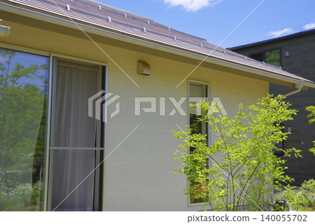Exterior view of a detached house with a garden surrounded by nature Exterior view of a detached house with a garden surrounded by nature 140055702