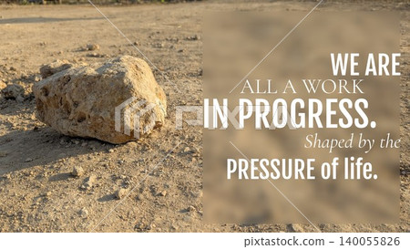 A lone rock sits on a dirt path under the sun, featuring the quote: "WE ARE ALL A WORK IN PROGRESS. Shaped by the PRESSURE of life." This image inspires strength transformation through adversity. A lone rock sits on a dirt path under the sun, featuring the quote: "WE ARE ALL A WORK IN PROGRESS. Shaped by the PRESSURE of life." This image inspires strength transformation through adversity. 140055826