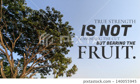 A tree's sunlit green canopy is viewed against a bright blue sky, featuring the quote, "TRUE STRENGTH IS NOT IN AVOIDING THE CUT BUT BEARING THE FRUIT." Inspires resilience growth after hardship. A tree's sunlit green canopy is viewed against a bright blue sky, featuring the quote, "TRUE STRENGTH IS NOT IN AVOIDING THE CUT BUT BEARING THE FRUIT." Inspires resilience growth after hardship. 140055945