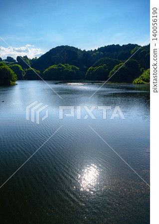 Nunome Dam in early summer: The evening sun reflected on the full water surface ① Nunome Dam in early summer: The evening sun reflected on the full water surface ① 140056190