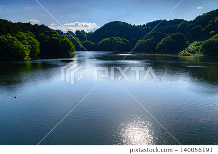Early summer at Nunome Dam: The evening sun reflected on the full water surface (Part 2) Early summer at Nunome Dam: The evening sun reflected on the full water surface (Part 2) 140056191