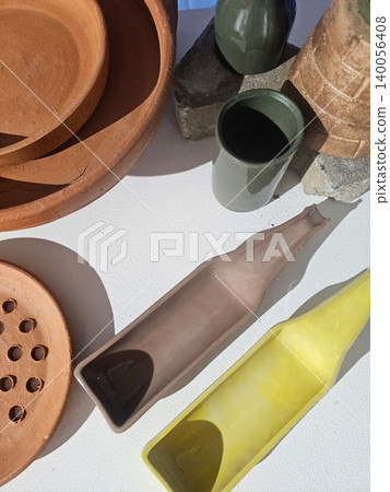 Collection of Handmade Ceramic and Terracotta Tableware with Minimalist Design and Natural Shadows Collection of Handmade Ceramic and Terracotta Tableware with Minimalist Design and Natural Shadows 140056408