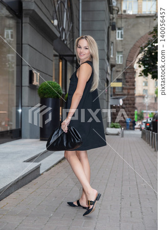 Cute blonde wearing a black dress 140056457