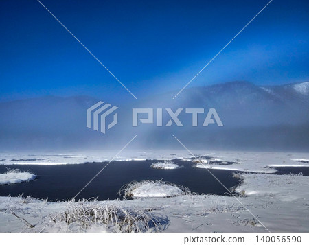 A white rainbow over the Oze Marsh in early winter and frozen ponds; a natural snowscape with space for copying. A white rainbow over the Oze Marsh in early winter and frozen ponds; a natural snowscape with space for copying. 140056590