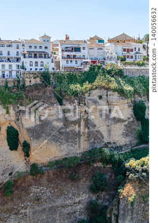 The picturesque town of Ronda in Spain is located on a cliff. The picturesque town of Ronda in Spain is located on a cliff. 140056632