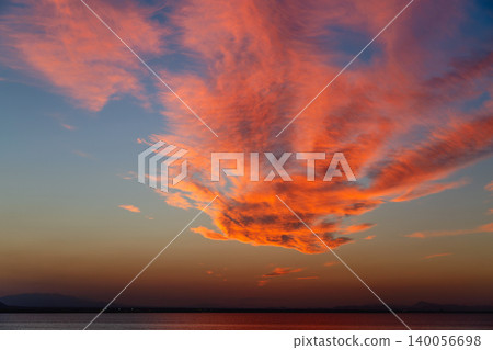 Stunning orange and pink clouds fill the evening sky during sunset Stunning orange and pink clouds fill the evening sky during sunset 140056698