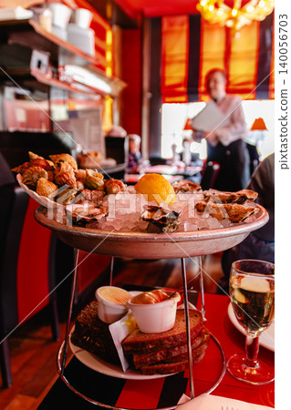 Oysters served on a platters surrounded by elegant dining atmosphere Oysters served on a platters surrounded by elegant dining atmosphere 140056703