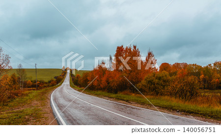 Scenic autumn road winding through colorful trees Scenic autumn road winding through colorful trees 140056751