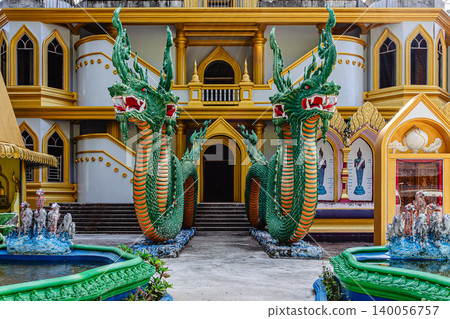 Vibrant dragon statues welcome visitors at Thai temple complex on a clear day Vibrant dragon statues welcome visitors at Thai temple complex on a clear day 140056757