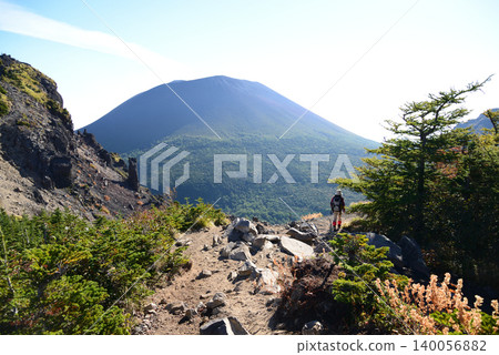 Mount Asama in early autumn, with a spear visible in the distance from its sheath. Mount Asama in early autumn, with a spear visible in the distance from its sheath. 140056882