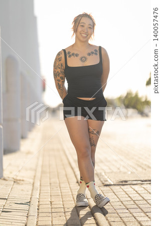 Young woman smiling while standing in urban setting 140057476