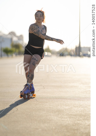 Tattooed woman enjoying roller skating in urban setting Tattooed woman enjoying roller skating in urban setting 140057528