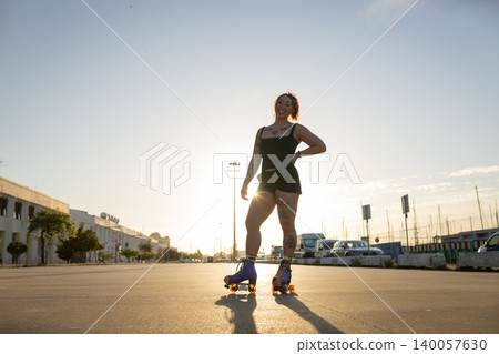 Young woman roller skating at sunset feeling freedom Young woman roller skating at sunset feeling freedom 140057630