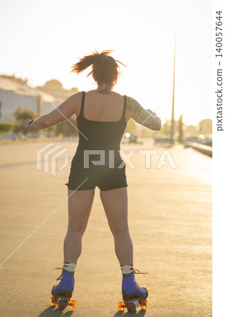 Woman enjoying roller skating during golden hour sunset Woman enjoying roller skating during golden hour sunset 140057644
