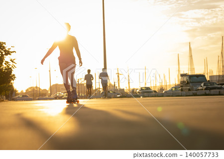 People exercising at sunset during golden hour along canal People exercising at sunset during golden hour along canal 140057733
