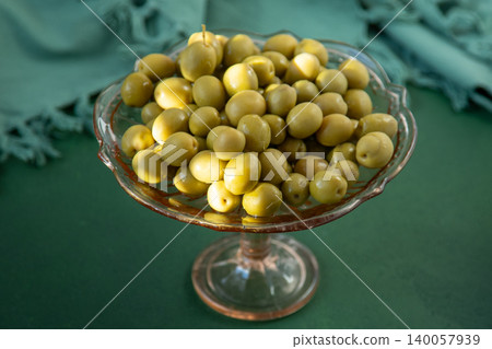 Green olives fruit close up top view, food background Green olives fruit close up top view, food background 140057939