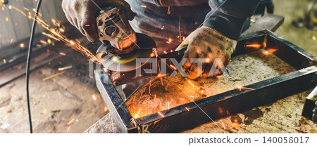 Skilled worker using an angle grinder to cut and grind metal, generating bright sparks in a workshop environment, focusing on craftsmanship and industrial work. Skilled worker using an angle grinder to cut and grind metal, generating bright sparks in a workshop environment, focusing on craftsmanship and industrial work. 140058017