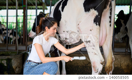 Dairy worker applying Milk Quality Testing before milking process in farm Dairy worker applying Milk Quality Testing before milking process in farm 140058505