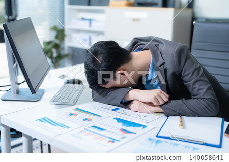 Young stressed asian businessman working in the office. Young stressed asian businessman working in the office. 140058641