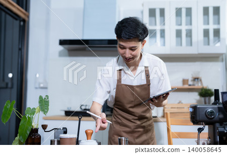 male barista checking coffee machine equipment. male barista checking coffee machine equipment. 140058645
