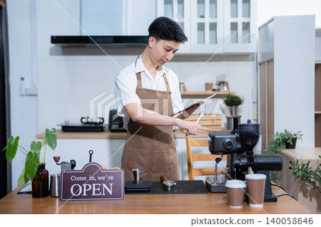 male barista checking coffee machine equipment. male barista checking coffee machine equipment. 140058646