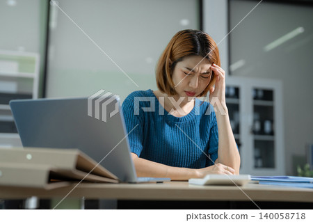 Tired asian businesswoman with headache at office, feeling sick at work. Tired asian businesswoman with headache at office, feeling sick at work. 140058718