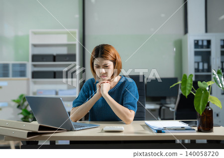 Stressed asian business woman working in the office. Stressed asian business woman working in the office. 140058720