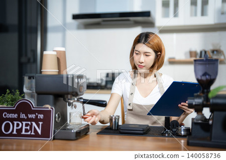 Female barista checking coffee machine equipment. Female barista checking coffee machine equipment. 140058736