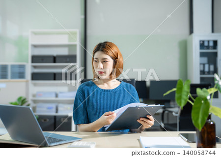 Businesswoman analyzing financial graphs, calculating company expenses, and planning investments, corporate, accounting, and economic strategy. 140058744